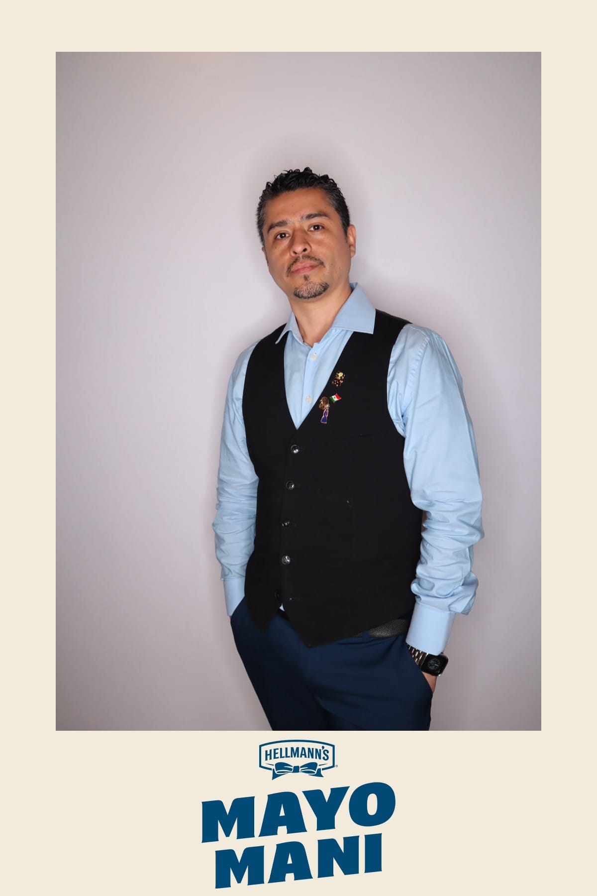 Guest in a vest with pins posing at the Hellmann's Mayo Mani photo booth
