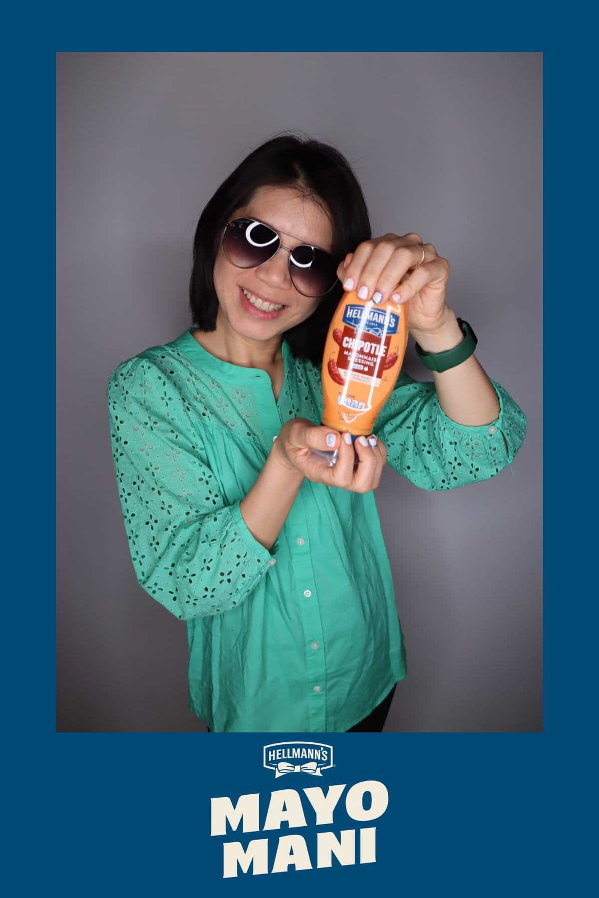 Guest in sunglasses holding a bottle of Hellmann's Chipotle Mayonnaise Dressing