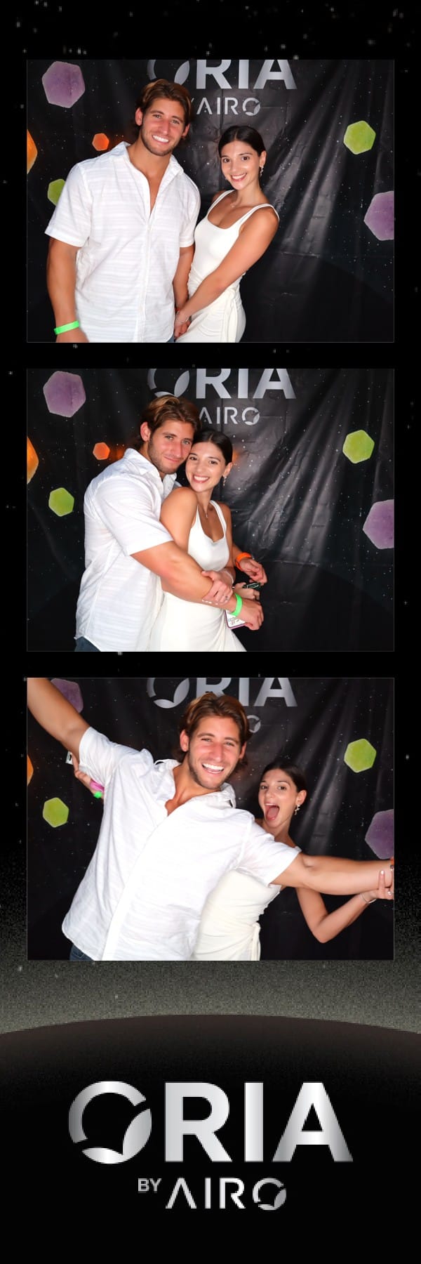Couple in white outfits posing at the Oria by Airo photo strip booth