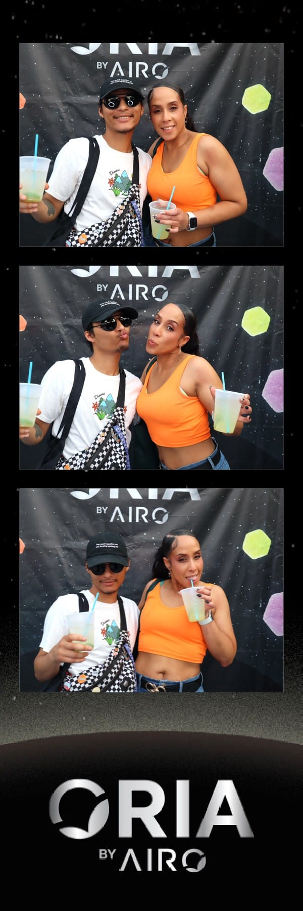 Couple posing with drinks at the Oria by Airo photo booth