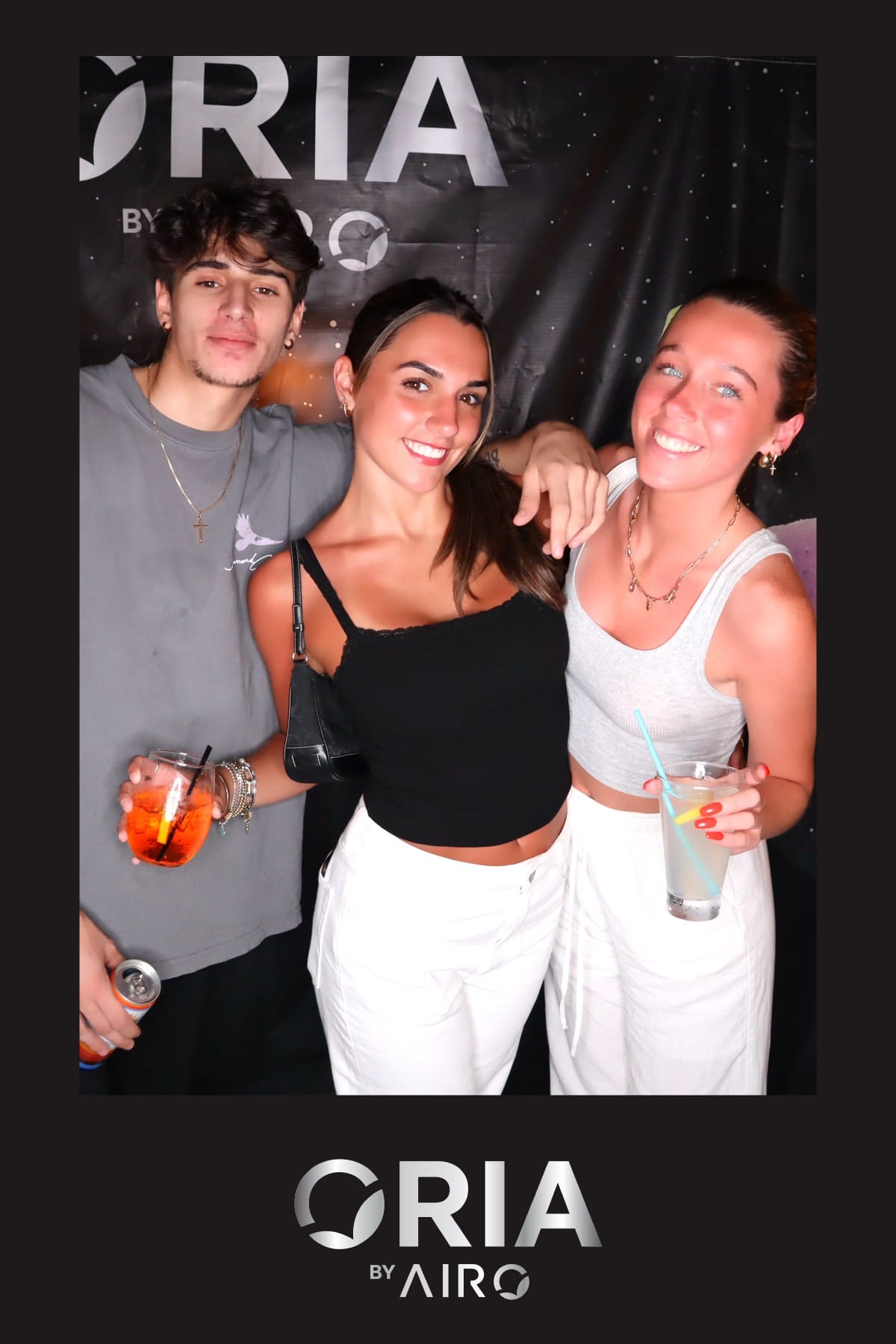 Group toasting with drinks at the Oria by Airo photo booth