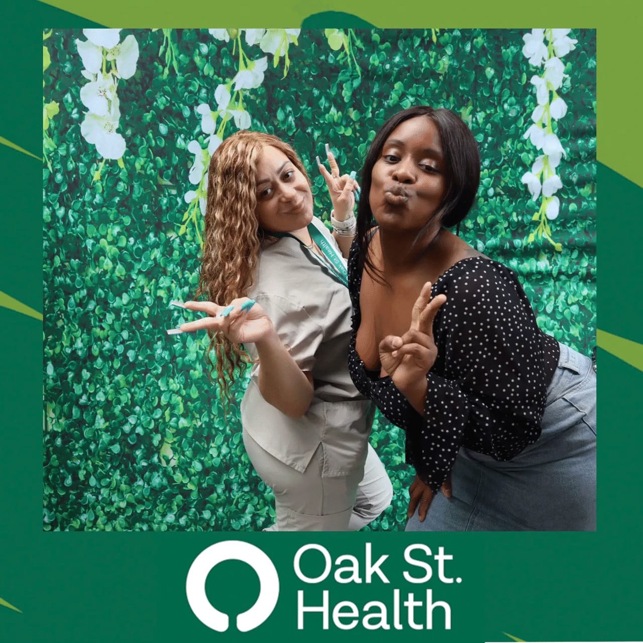 Elderly guest and Oak St. Health team member posing together at the flower wall
