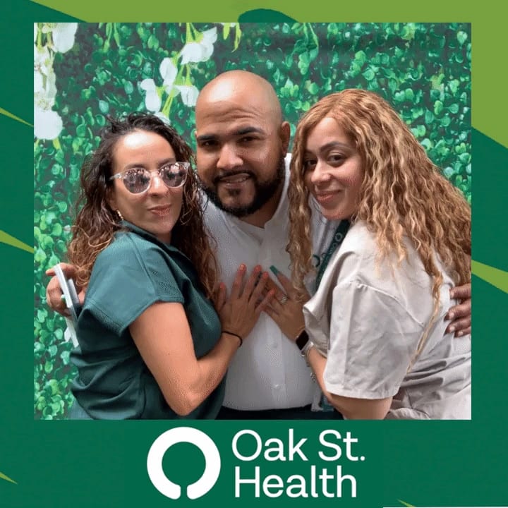 Two Oak St. Health team members posing together, peace signs up