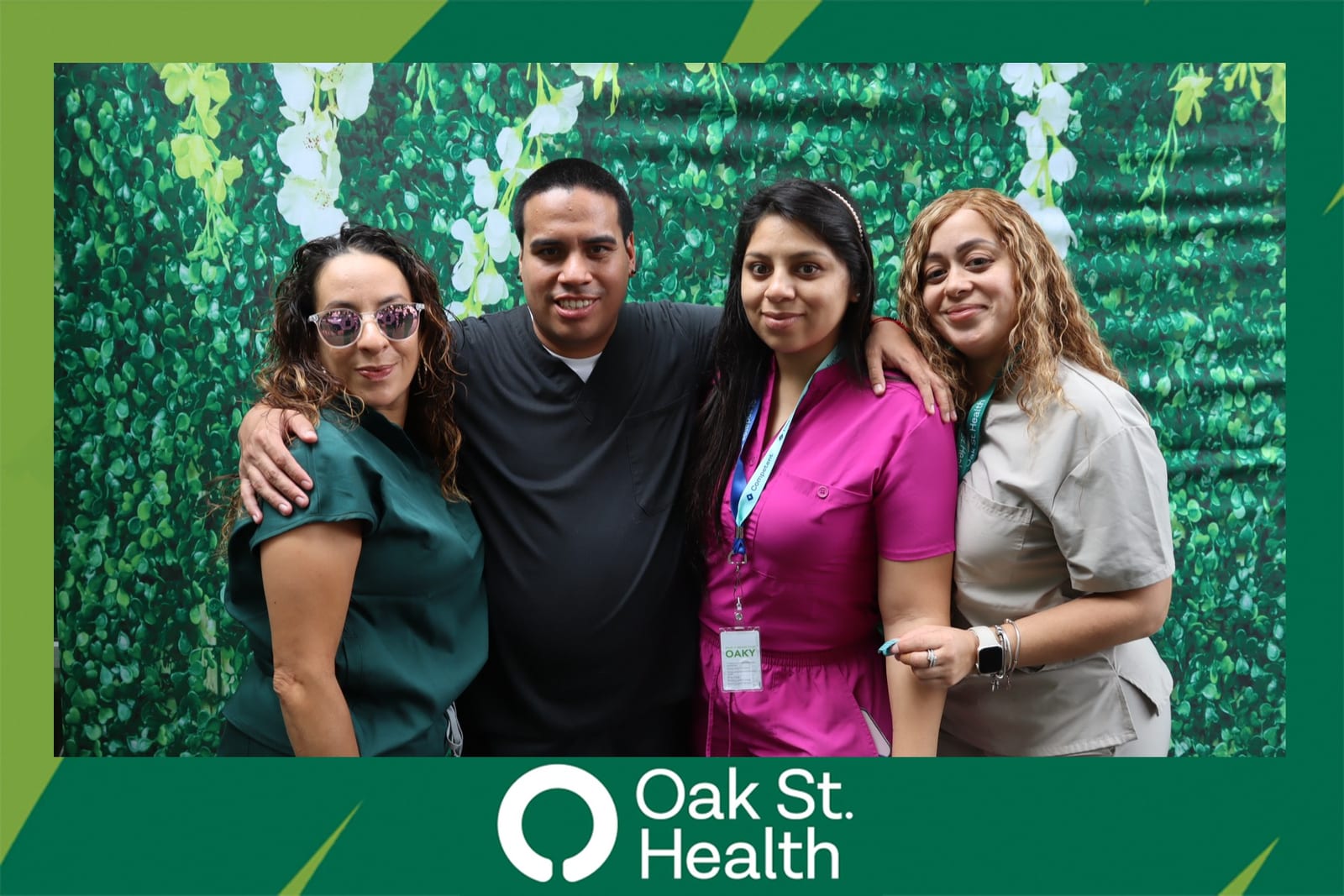 Couple posing together at the Oak St. Health flower wall booth