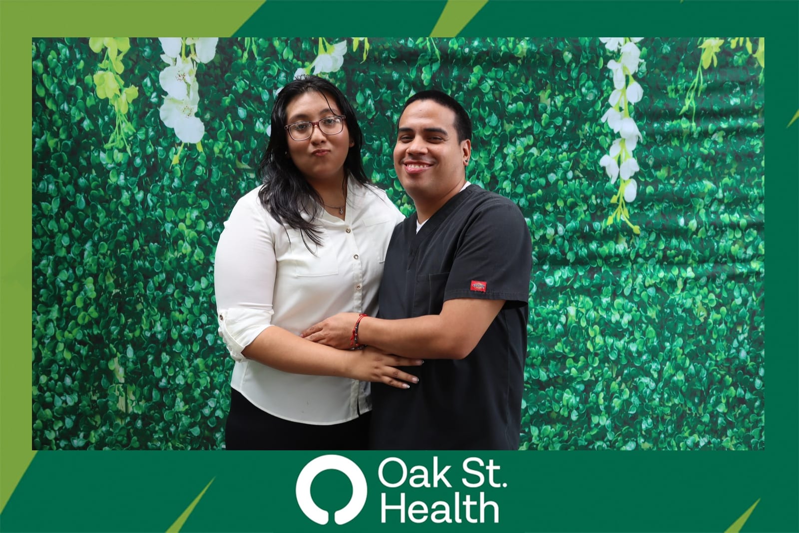 Five Oak St. Health team members posing together at the flower wall