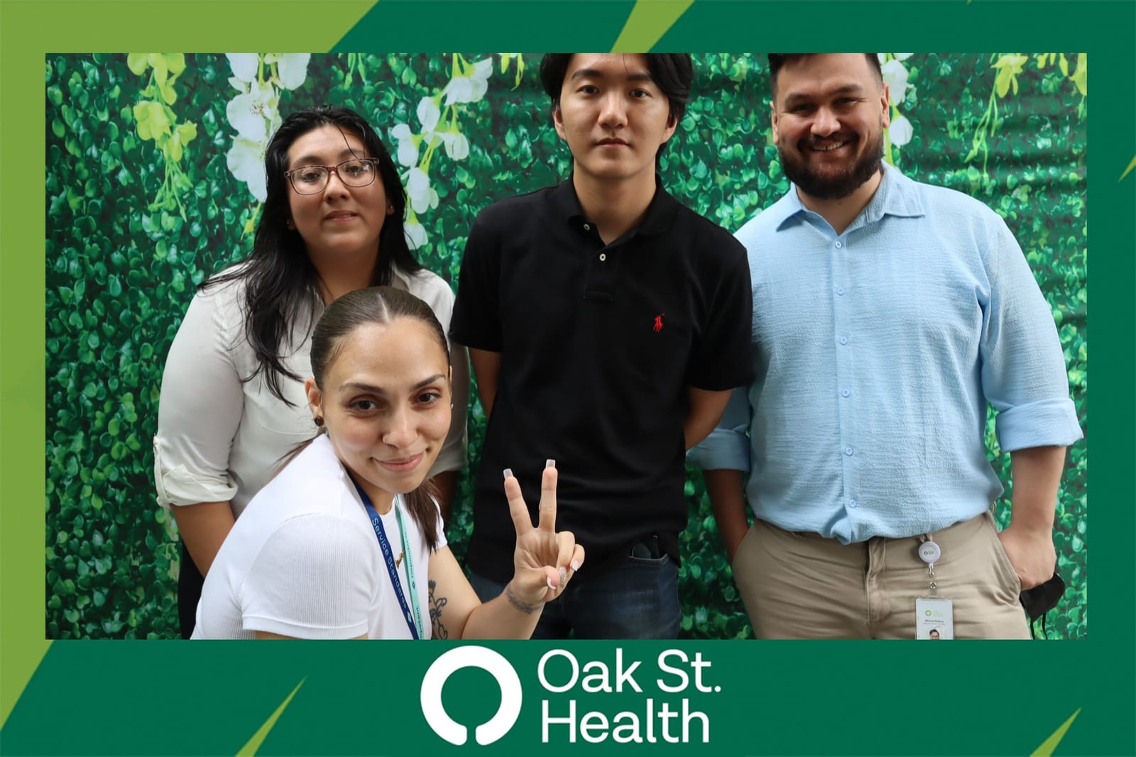 Four Oak St. Health team members posing together, one giving a peace sign