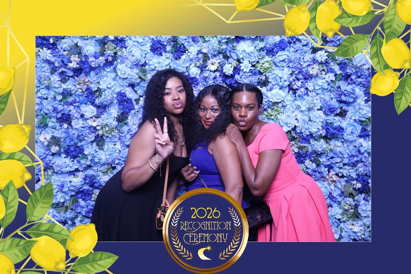 Three guests posing at the blue flower wall at the recognition ceremony