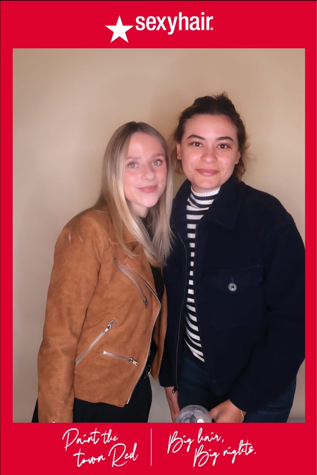 Two SexyHair team members posing together at the Paint the Town Red activation