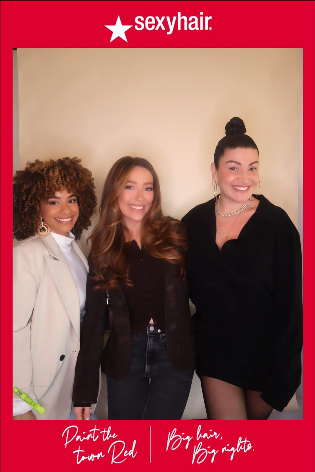 Three SexyHair team members posing together, one carrying a tote bag