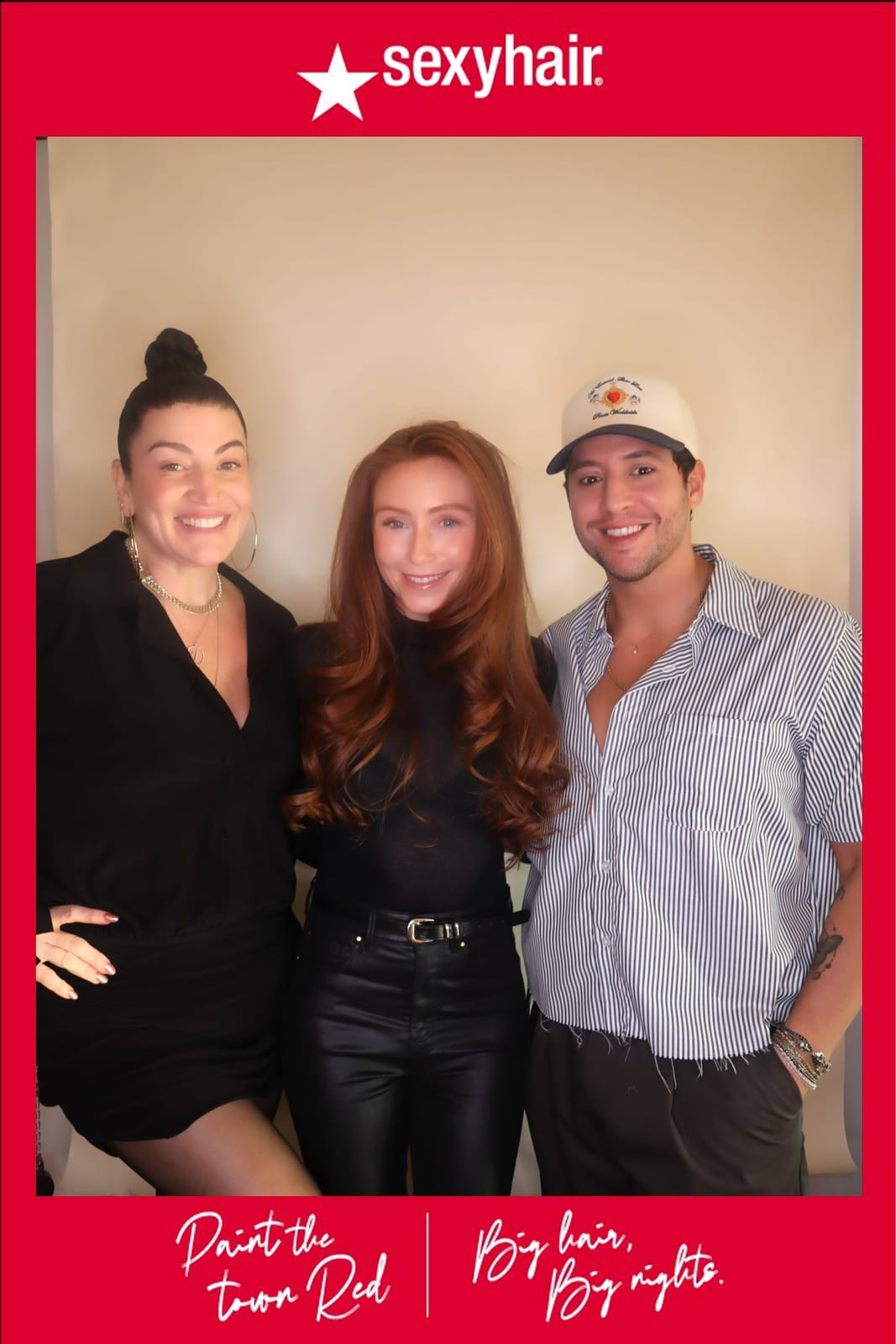 Guest holding two SexyHair styling product cans, laughing at the photo booth