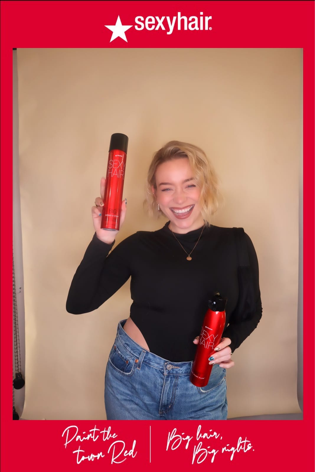 Guest posing with SexyHair styling products, low-rise jeans and a black bodysuit