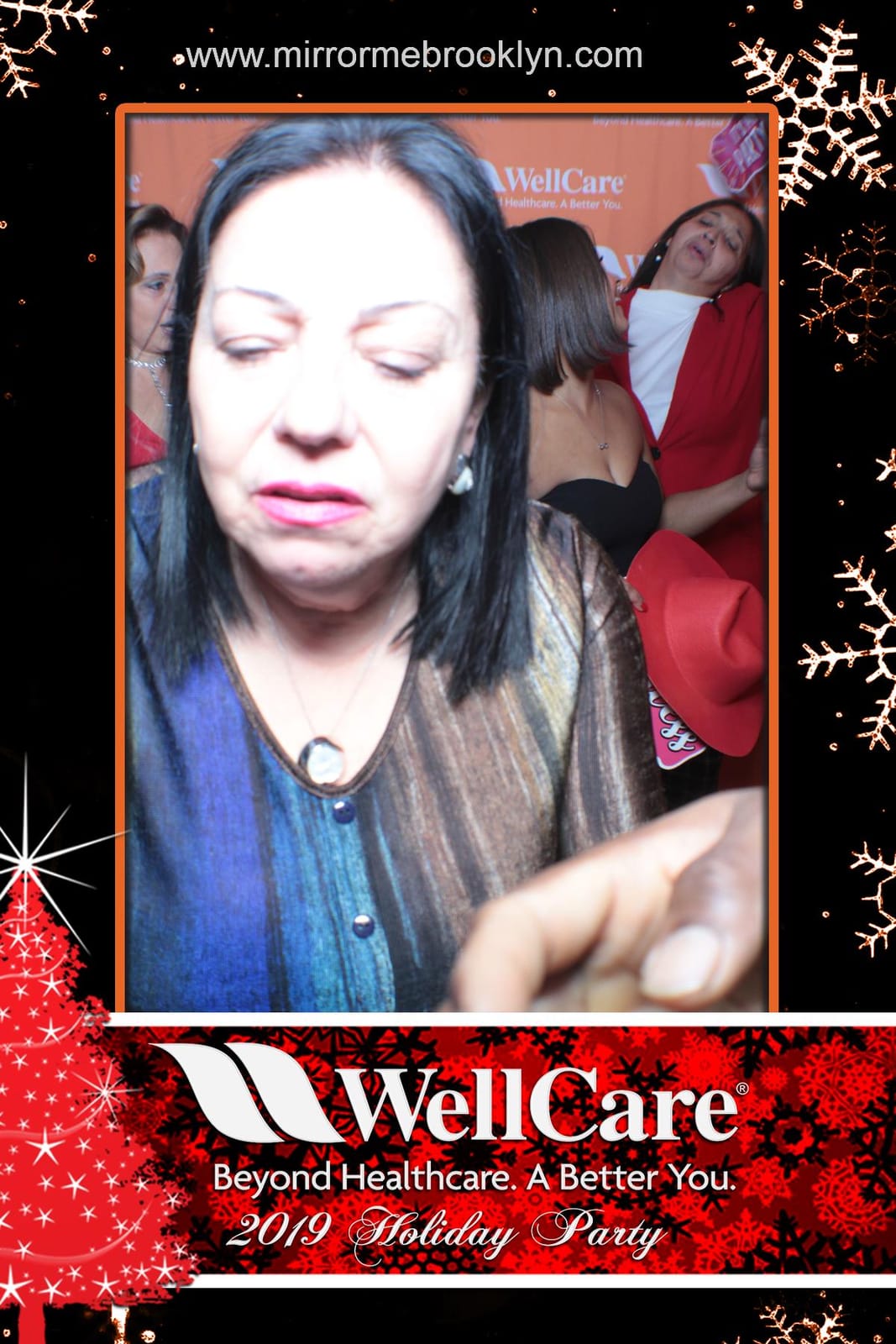 WellCare colleagues celebrating at the holiday photo booth