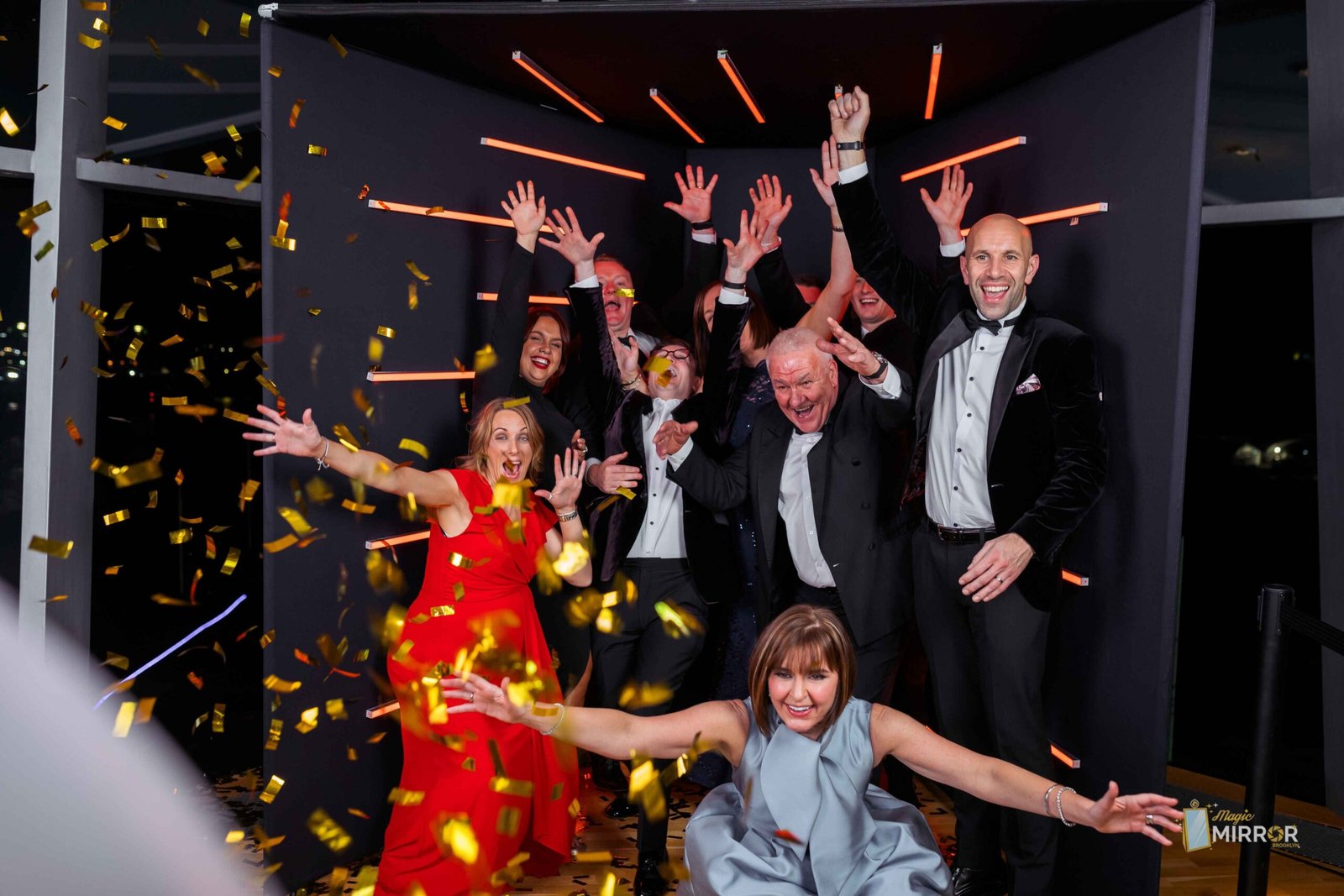 Group celebrating with confetti in front of the booth