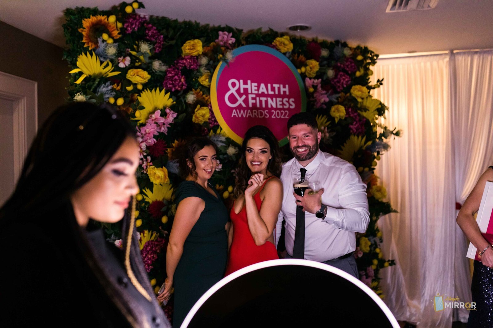 Roaming booth capturing guests at the Health and Fitness Awards flower wall