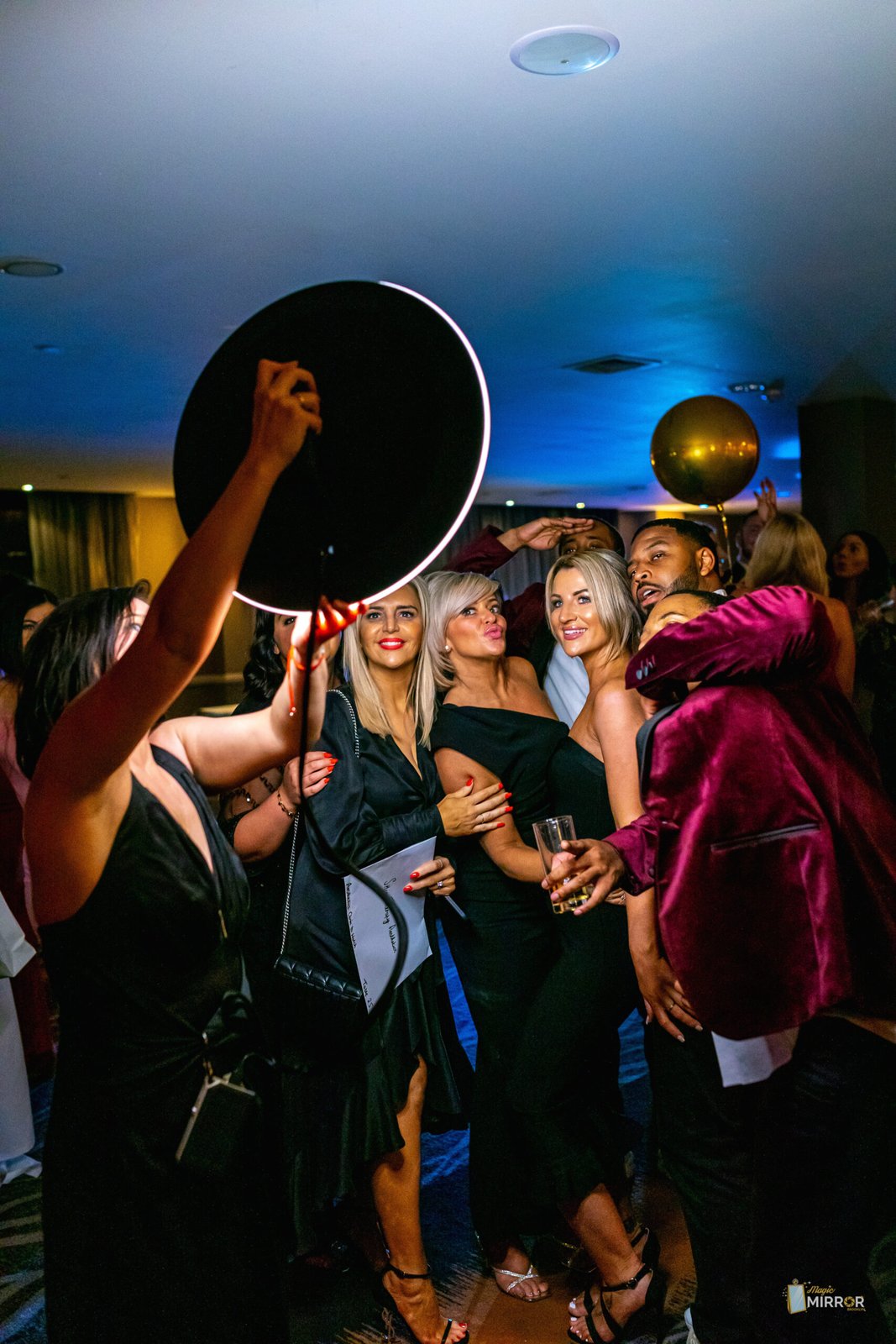 Party guests crowding into a roaming booth shot