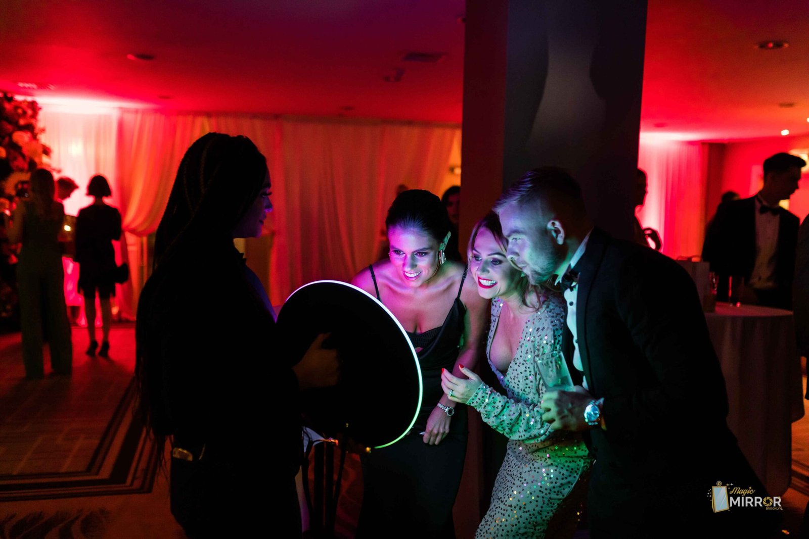 Roaming booth working the room at a red-lit party