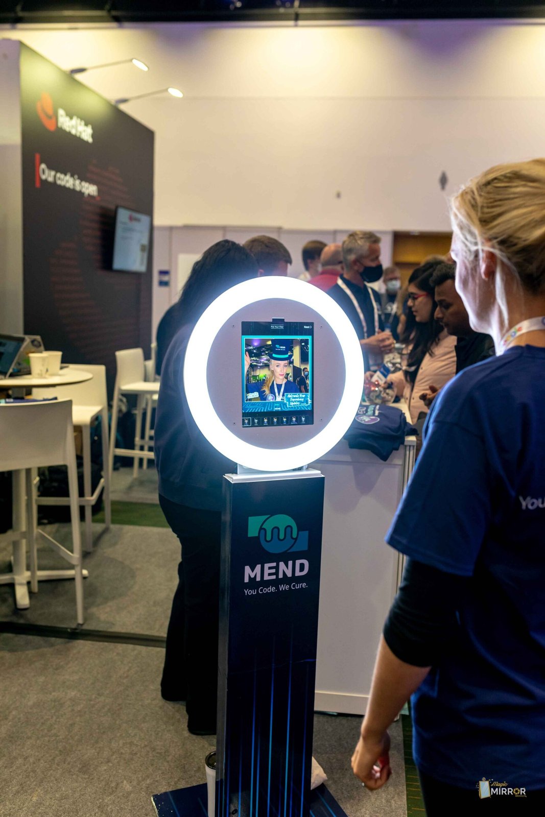 Ring-light selfie kiosk drawing attendees at a tech conference booth