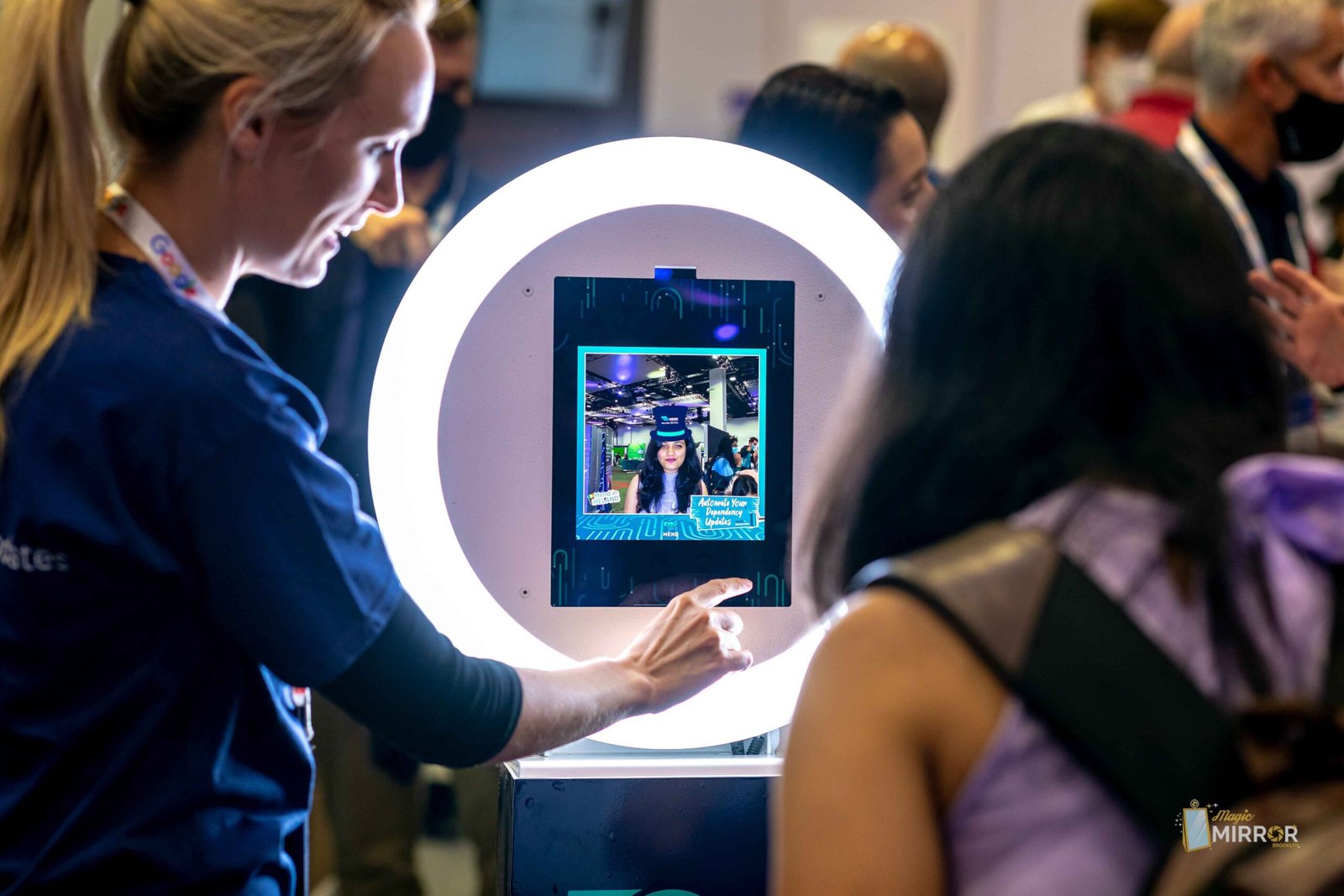 Guest using the touchscreen on a ring-light booth at a trade show